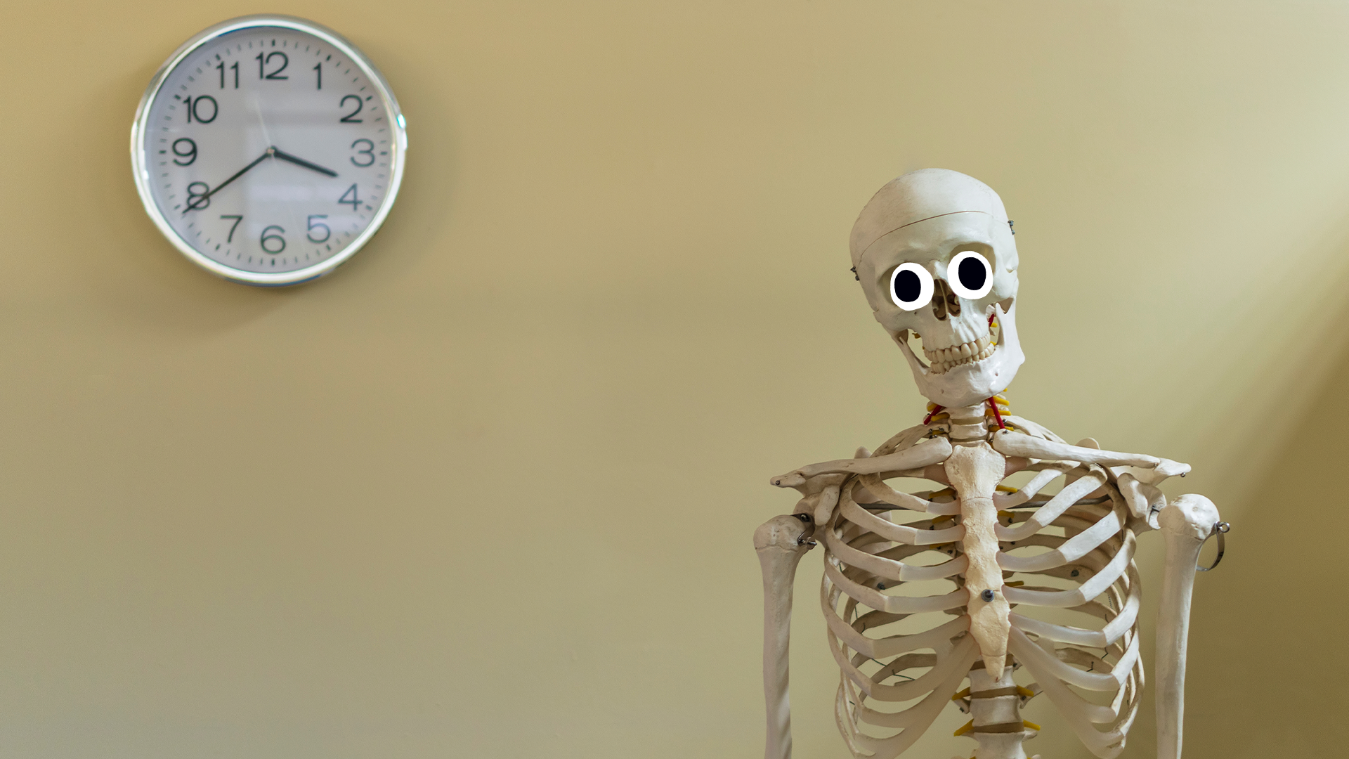 Skeleton in front of a clock