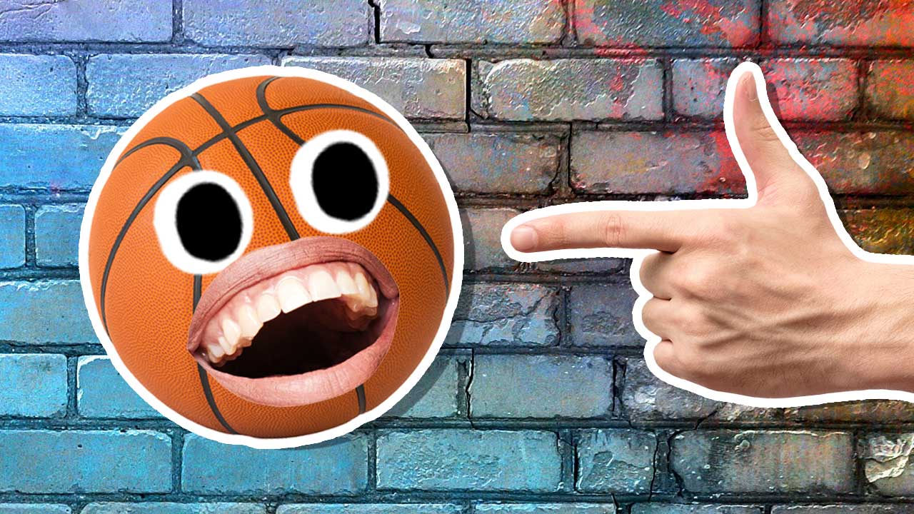 A hand pointing at a laughing basketball