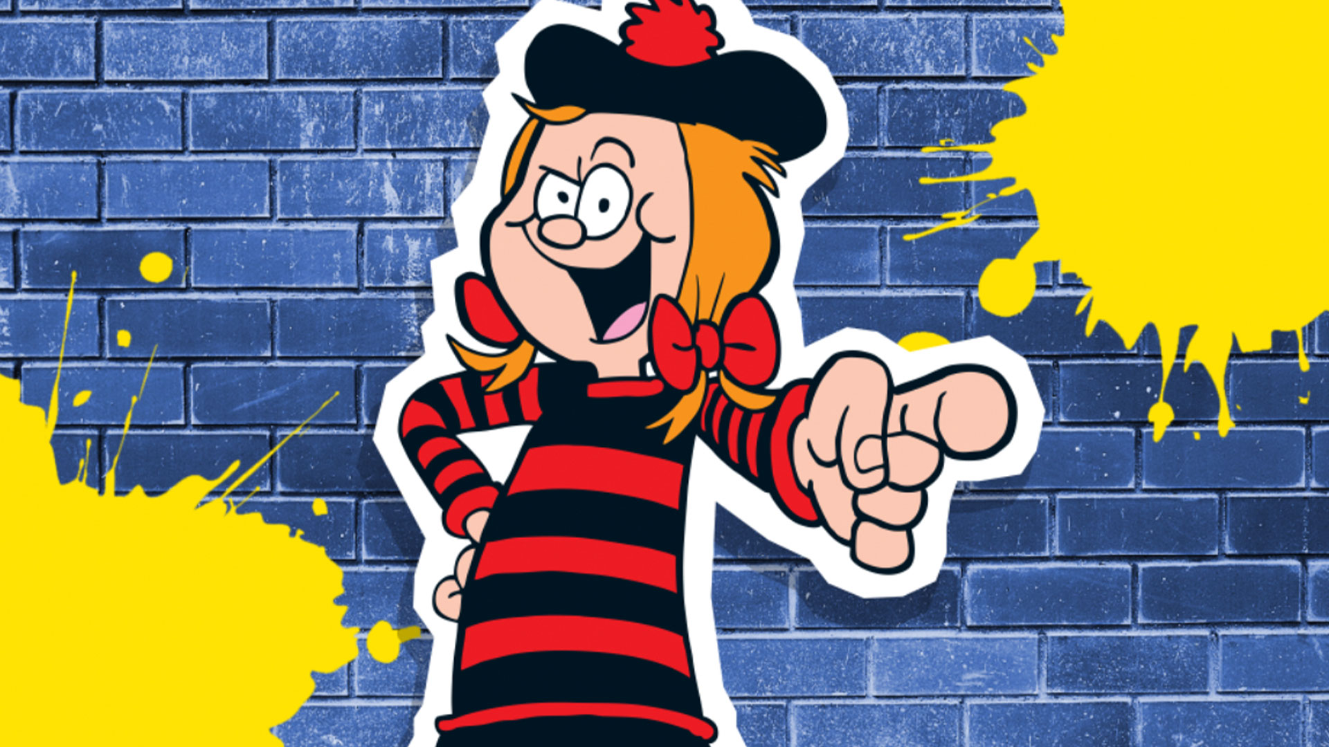 Minnie the Minx pointing in front of a brick wall