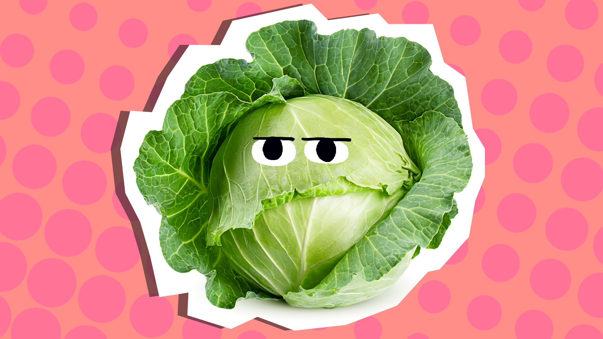 A cabbage against a pink spotty background 