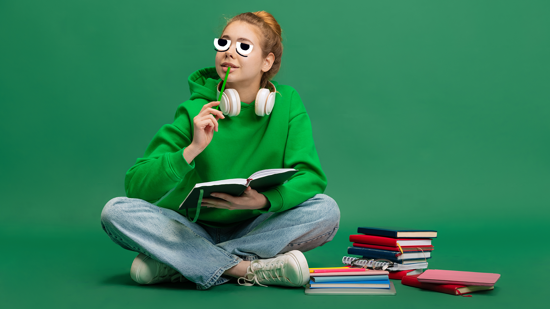 A girl in a green hoodie reading books