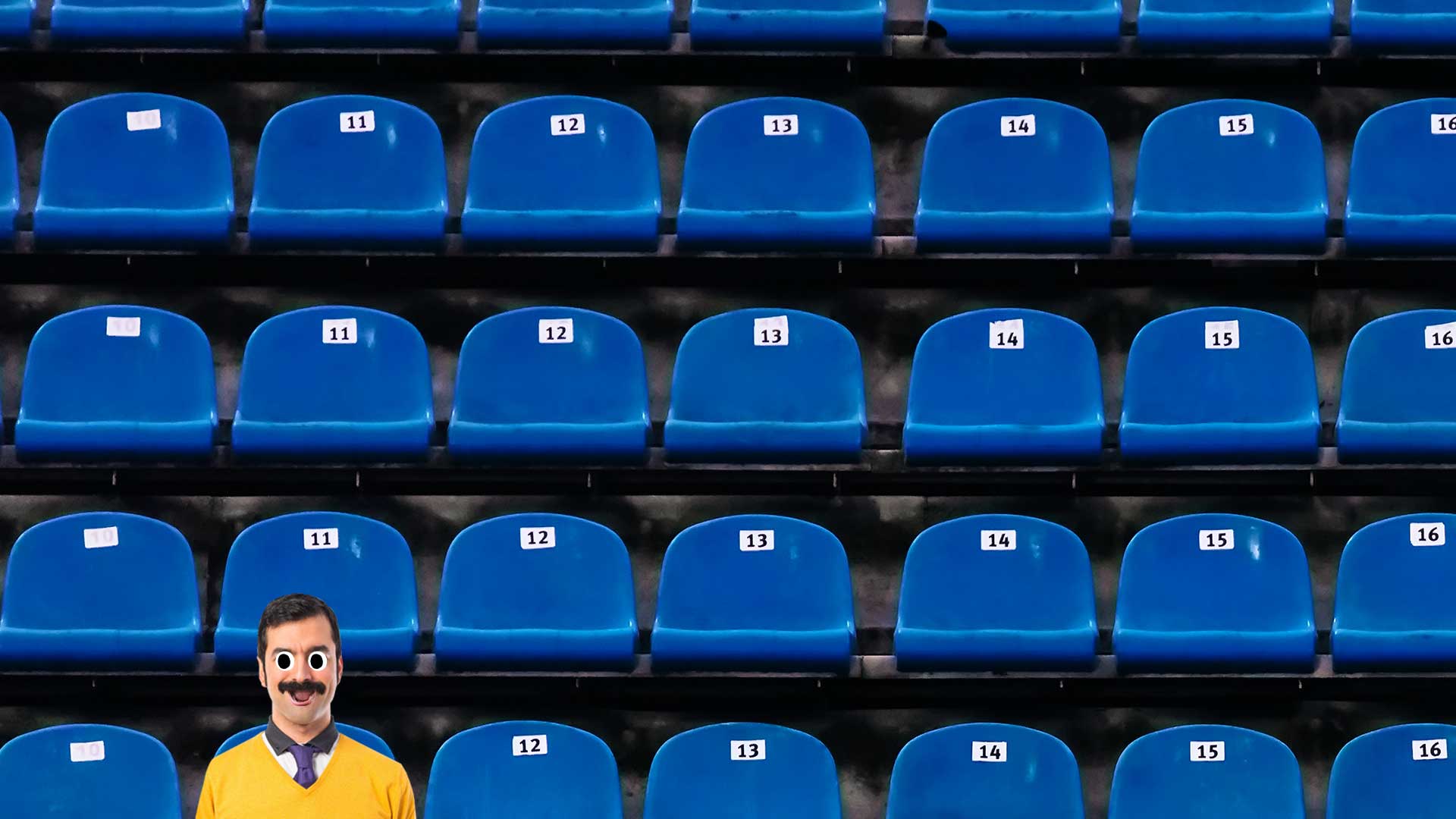 A man sitting in a football stadium