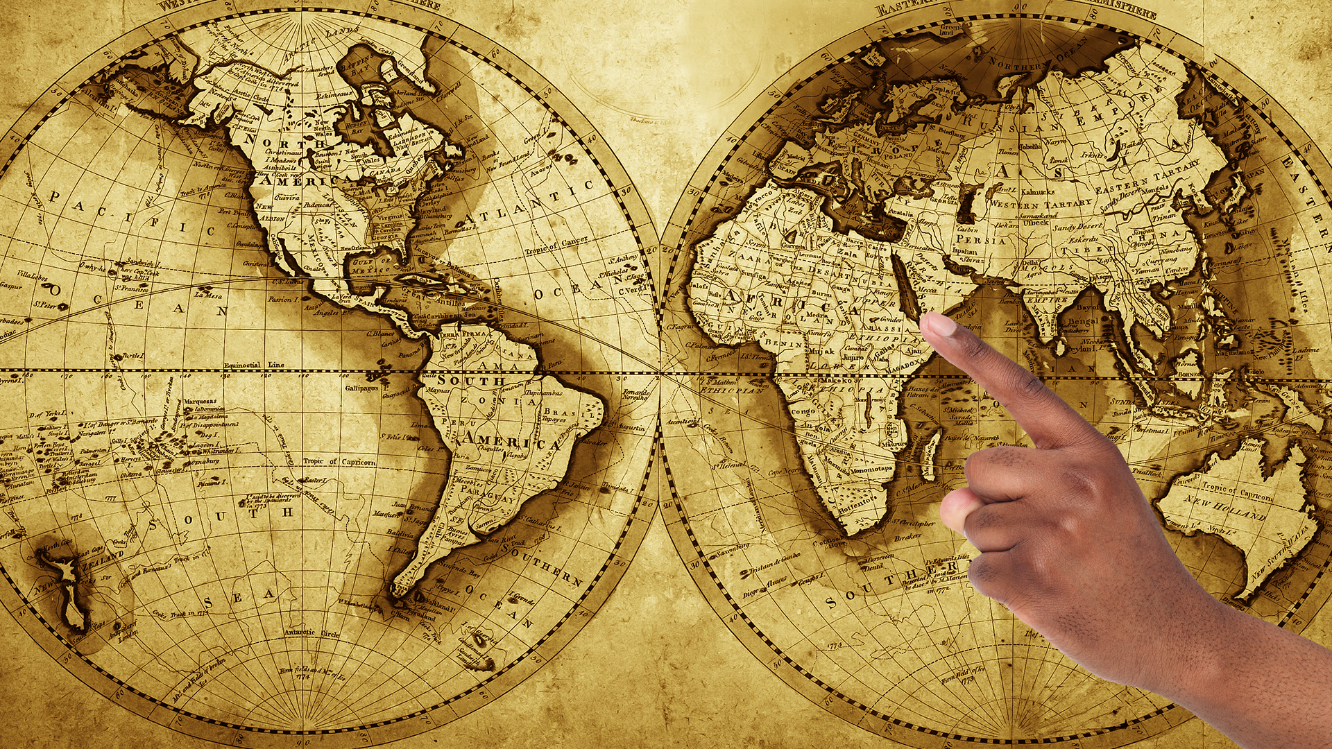 Map of the world and finger pointing