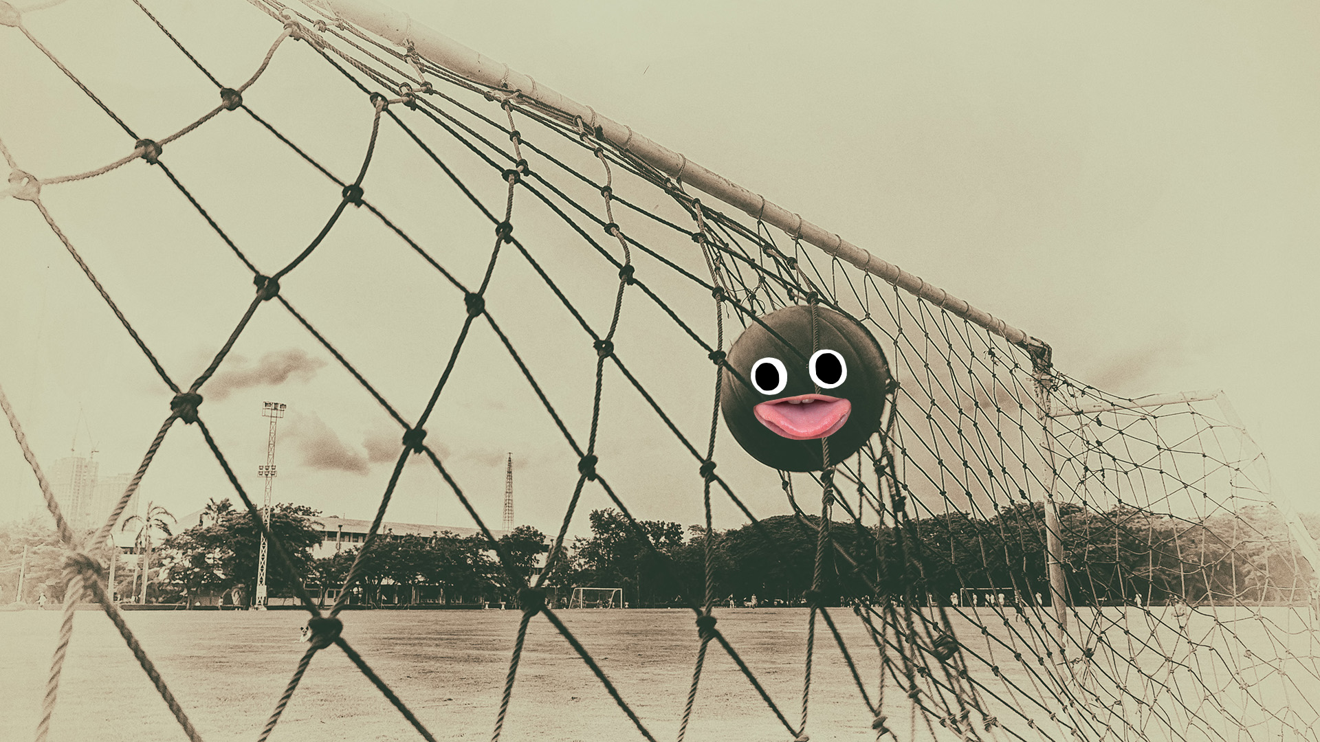 An old photo of a football hitting the back of the net