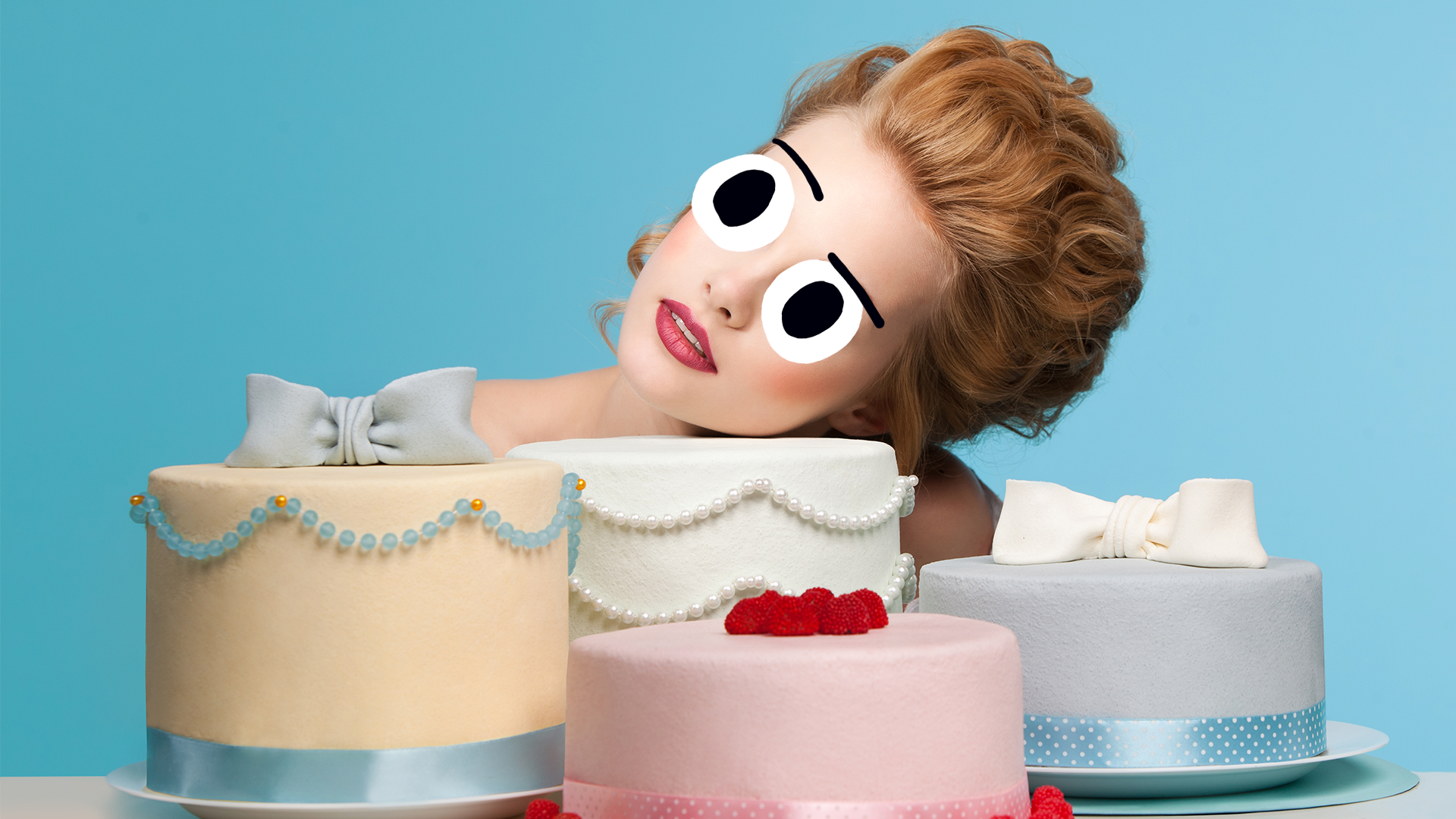 A woman examining some fancy cakes
