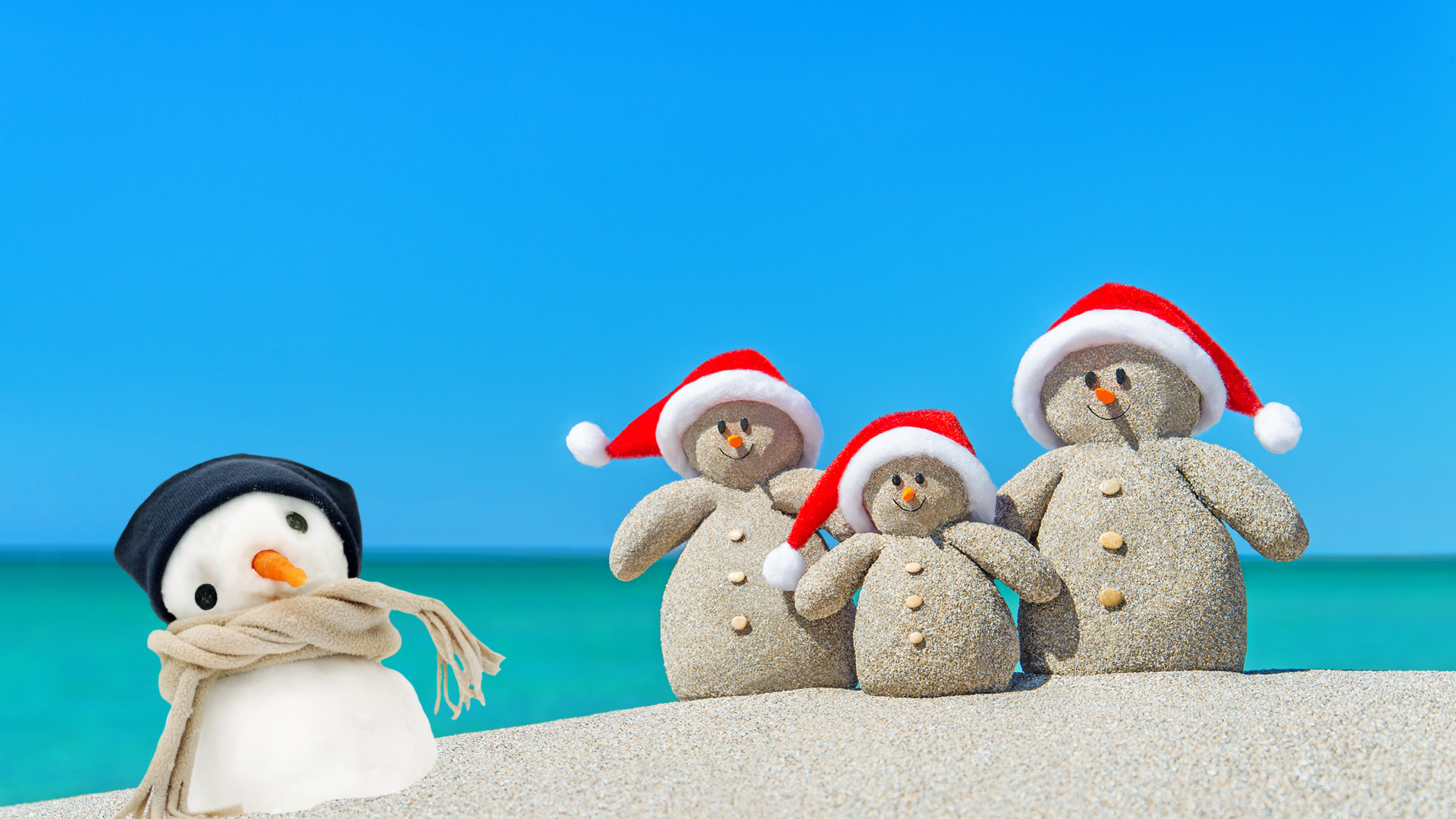 Snowman and sand sculptures on a beach