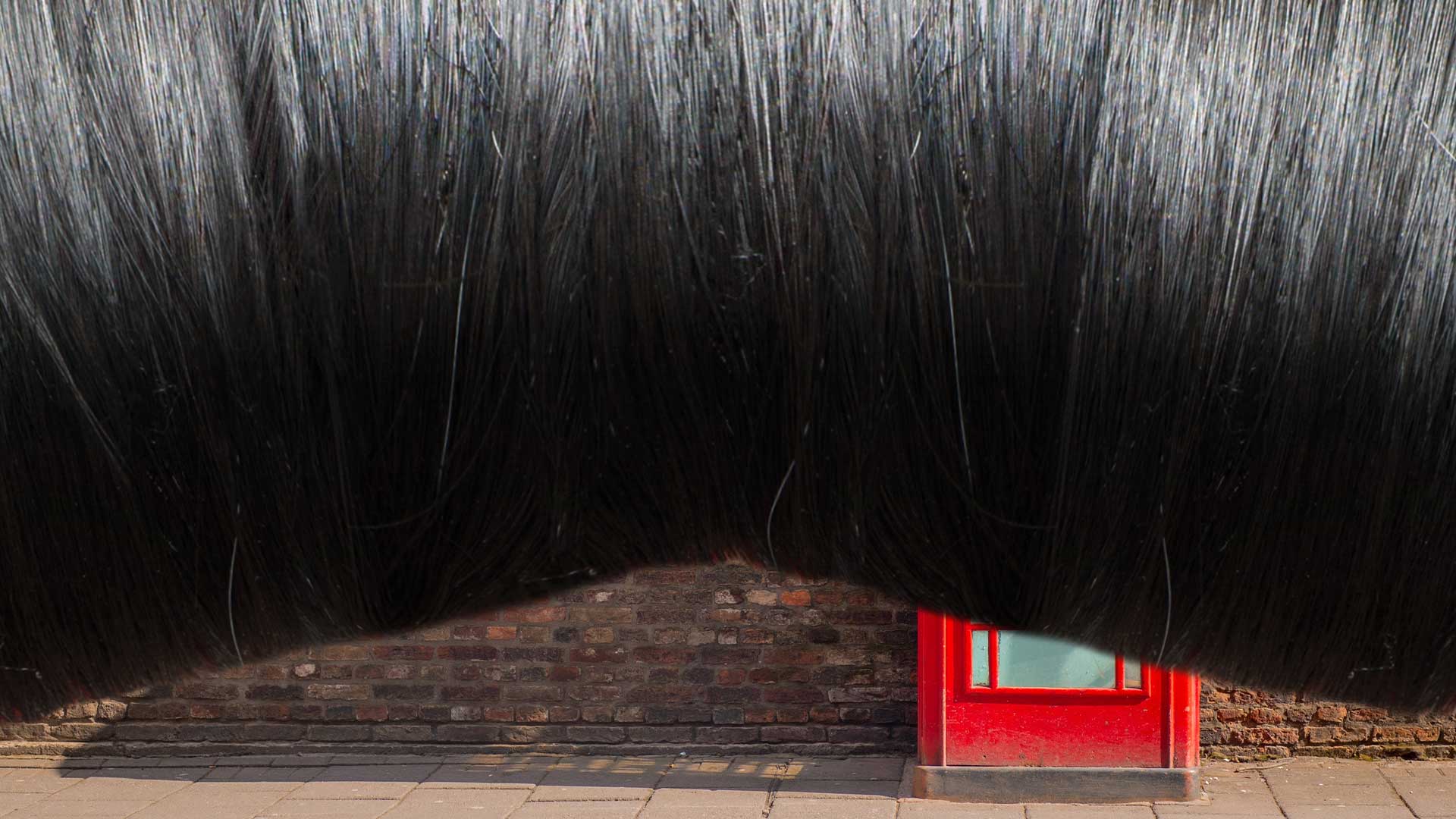 A long fringe obscuring an object in a British street