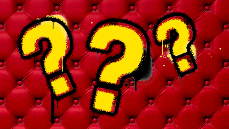 Question marks on red upholstered background