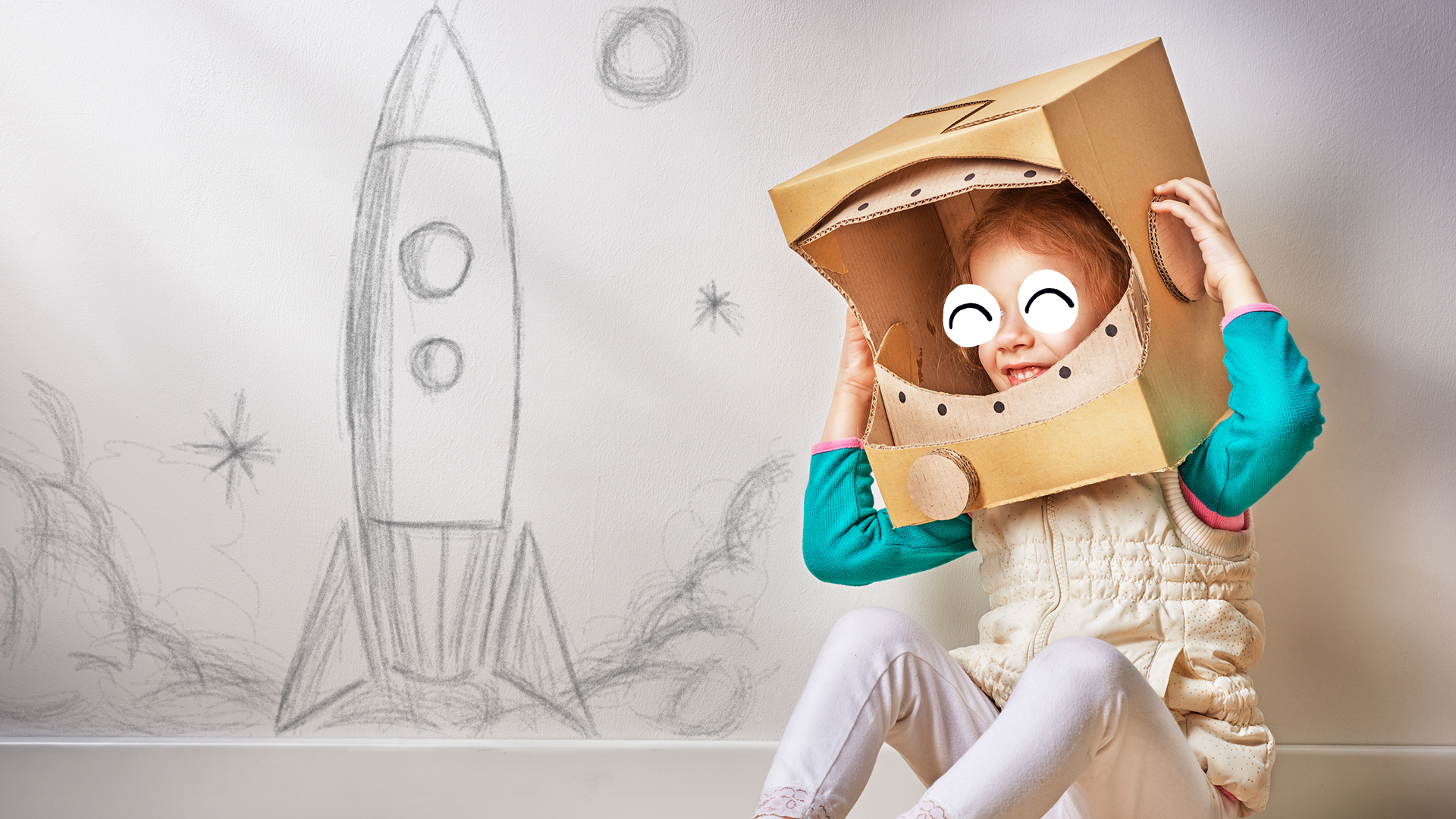 A child using a cardboard box as an astronaut helmet