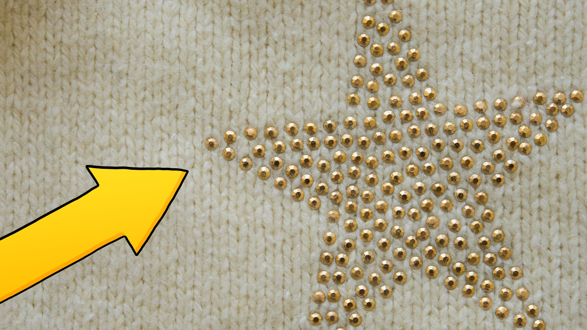Gold star on knitted background and arrow