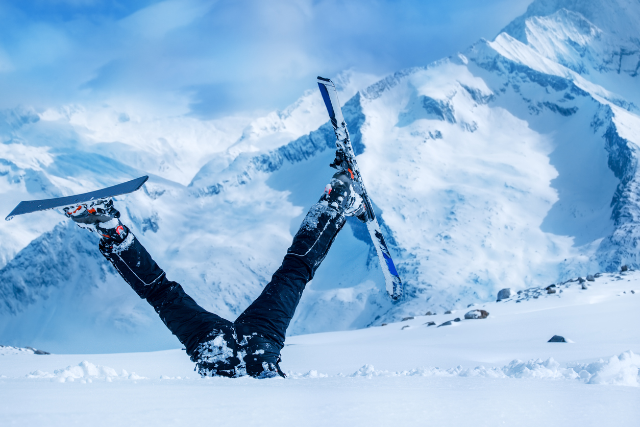 A skier upside down in the snow