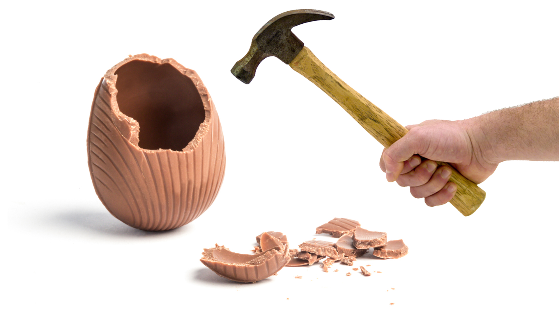 Easter egg being broken with a hammer