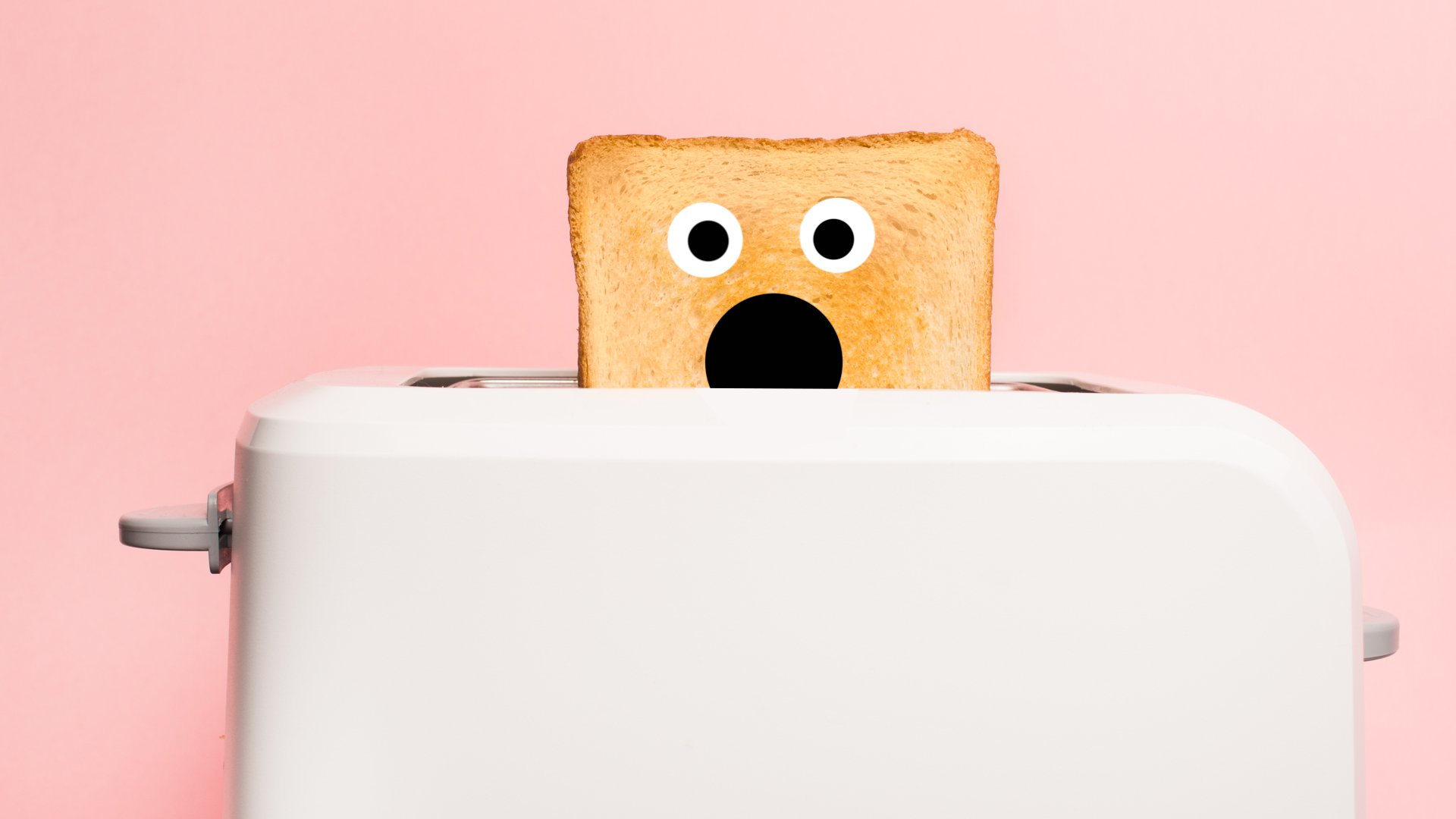 A toaster with a shocked piece of toast popping up