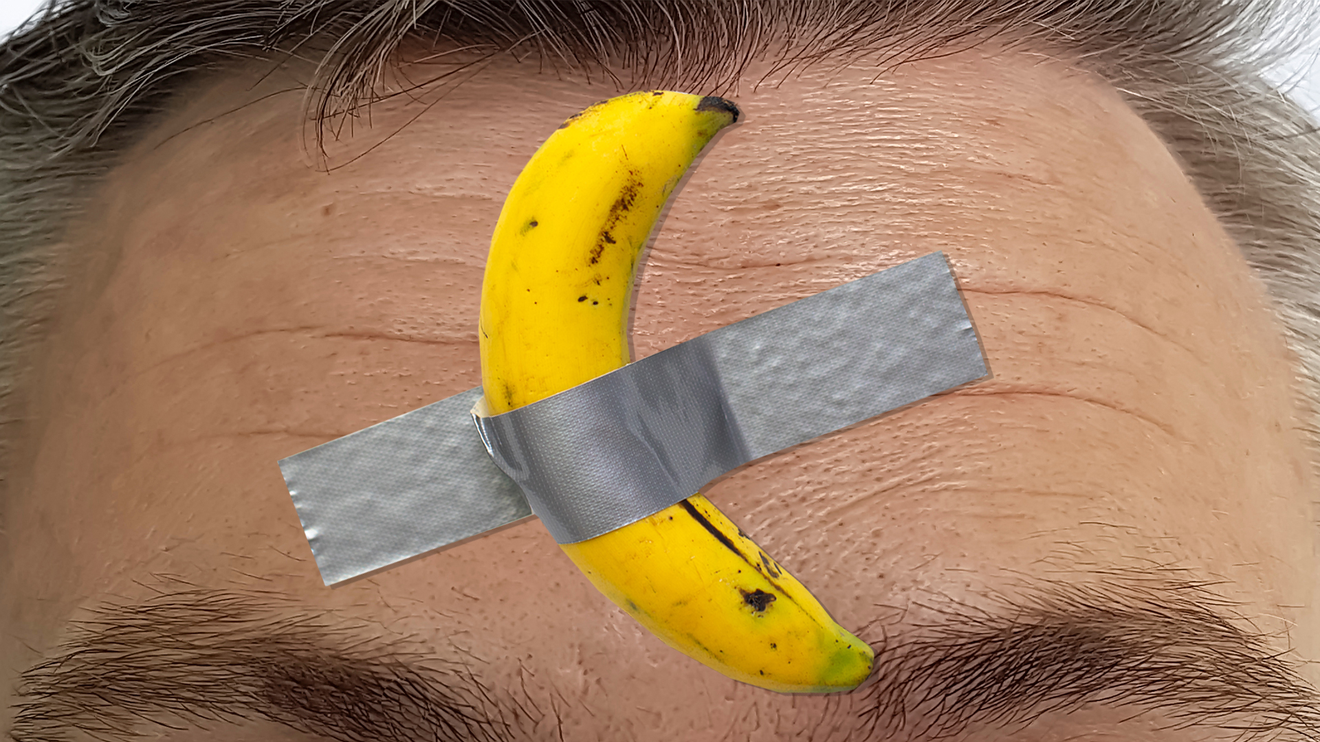 A banana taped on a man's forehead