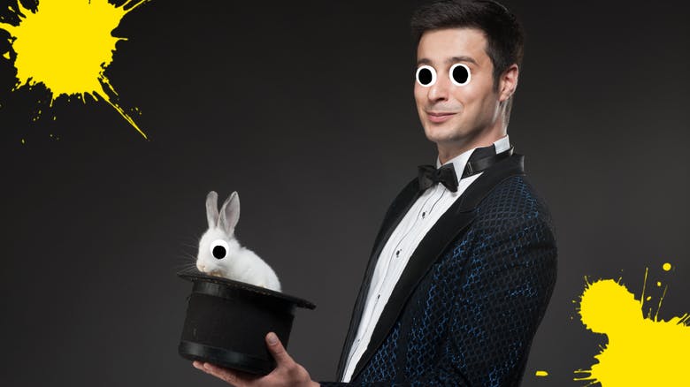 A magician holding a rabbit in a hat