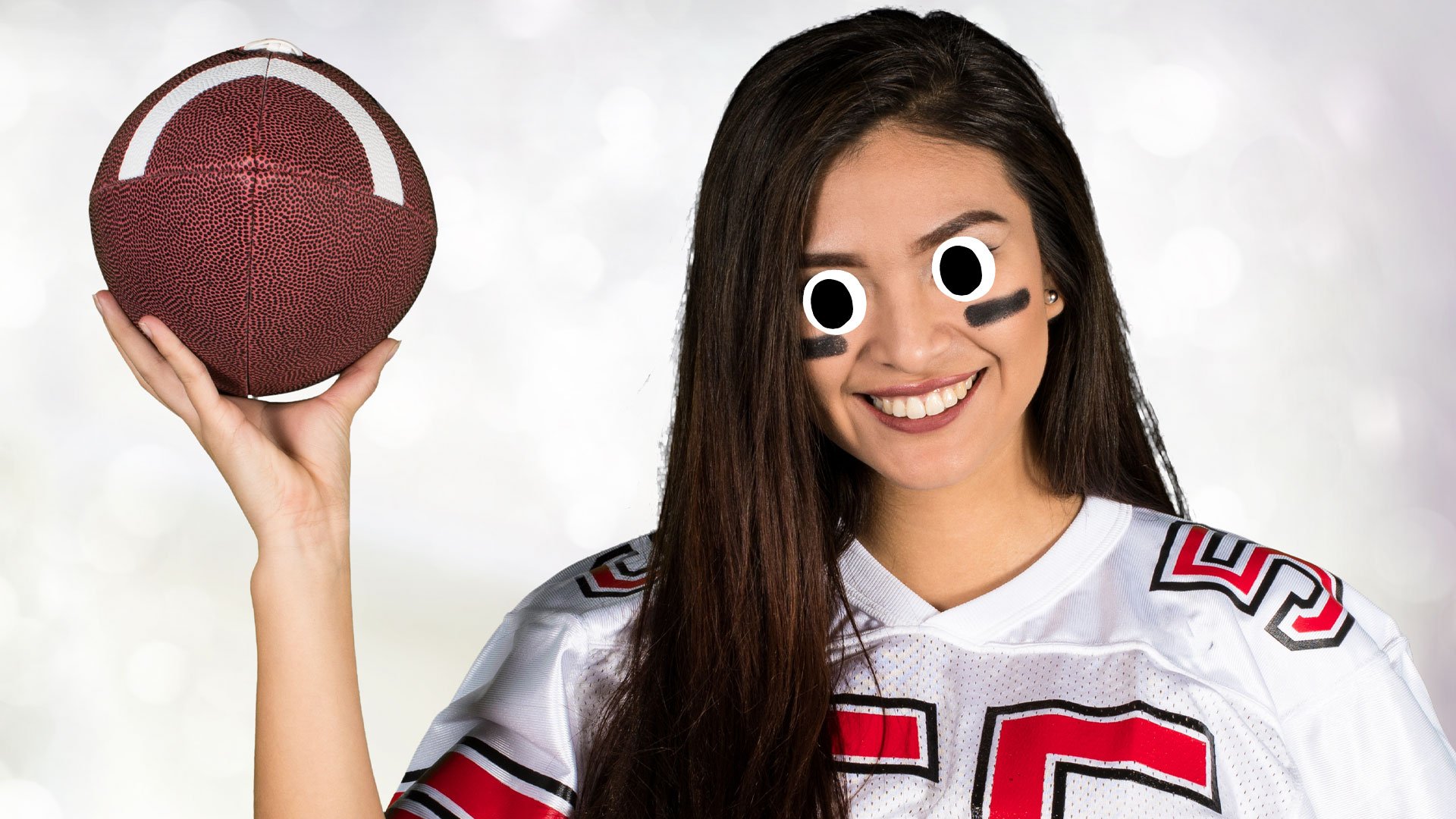A woman holding an American football