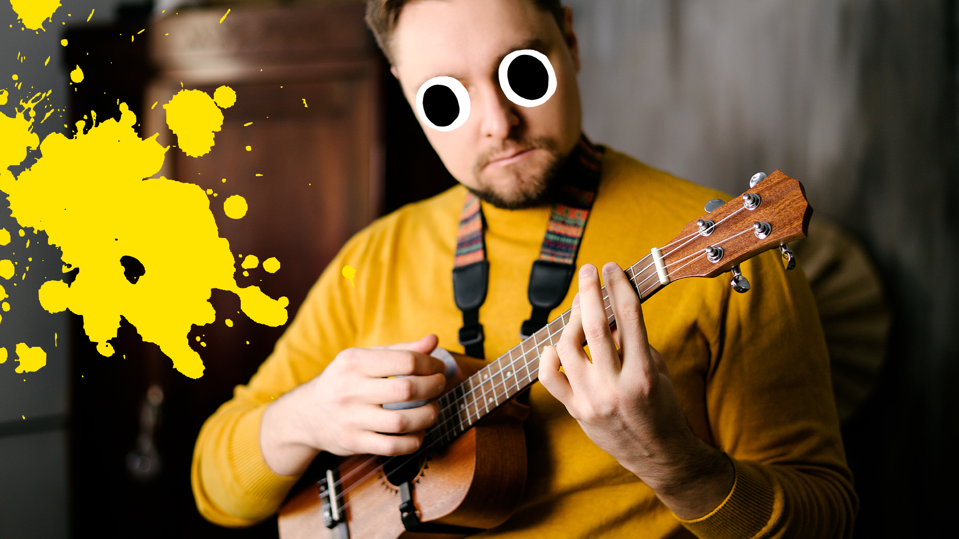 Man playing ukulele with yellow splat