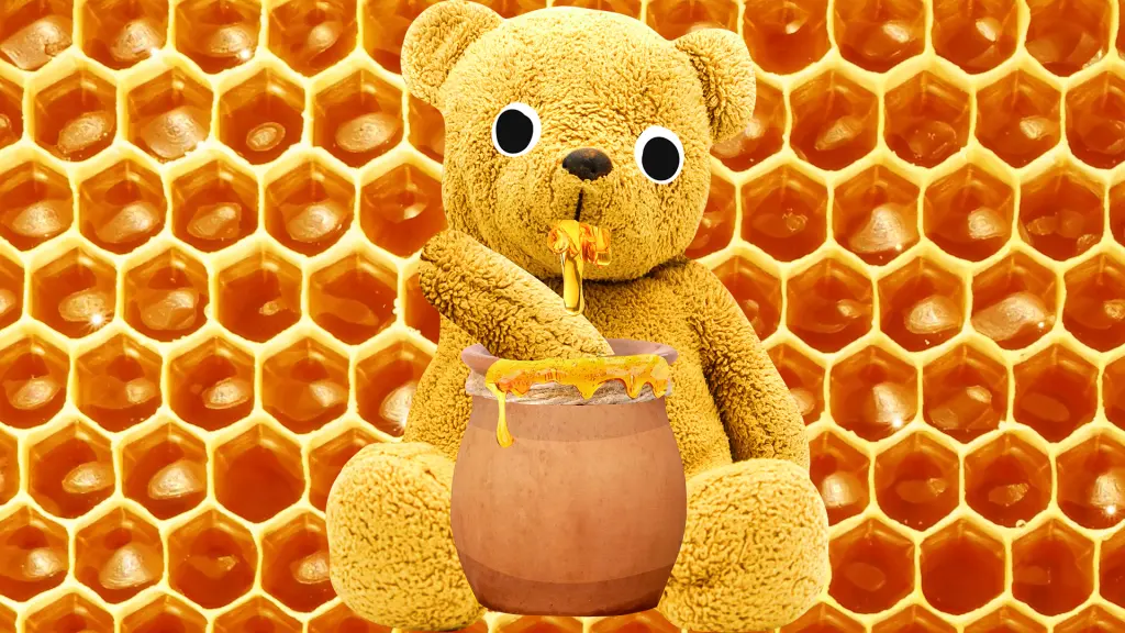 A toy bear eating honey