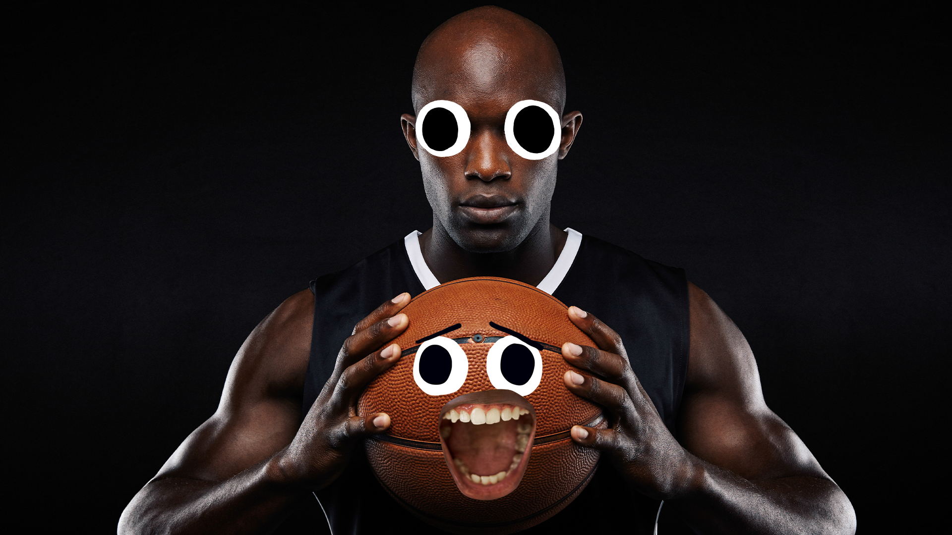 Basketball player holding goofy basketball on black background 