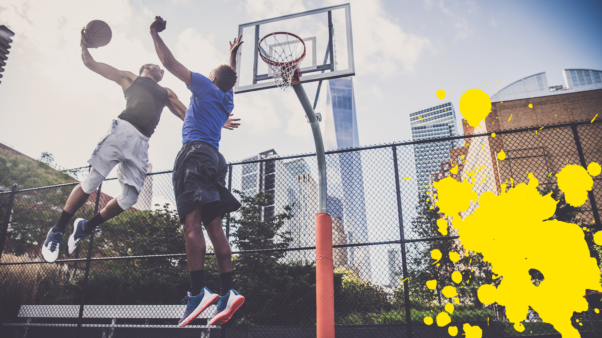 Two basketball players in outdoor court with yellow splat 