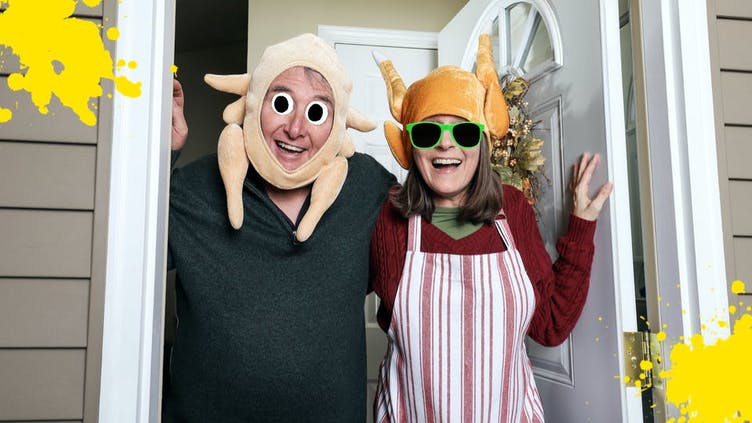 A couple wearing Thanskgiving turkey costumes