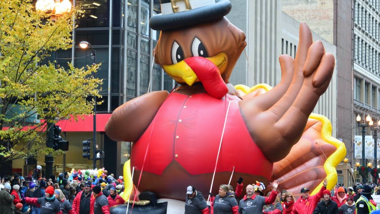 An inflatable turkey at a parade