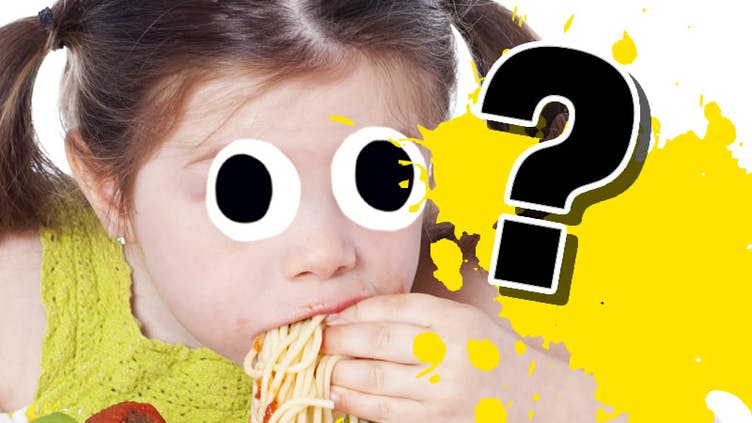 A child eating noodles or spaghetti