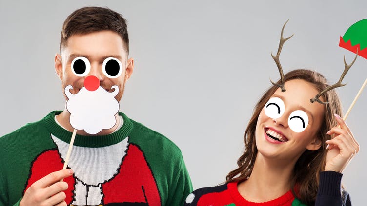 A man and woman with Christmas accessories on