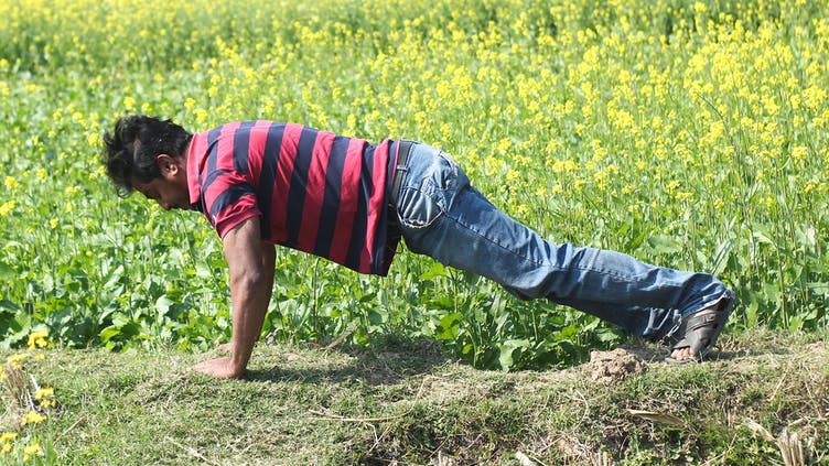 A man exercising in a field