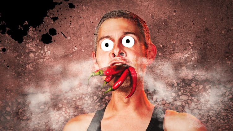 A man eating chillies