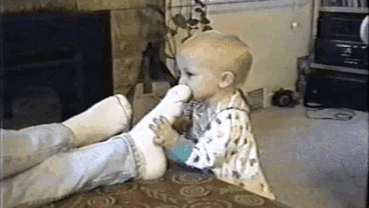 A gif of a child smelling stinky socks