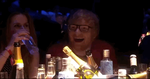 Ed Sheeran clapping at an awards ceremony