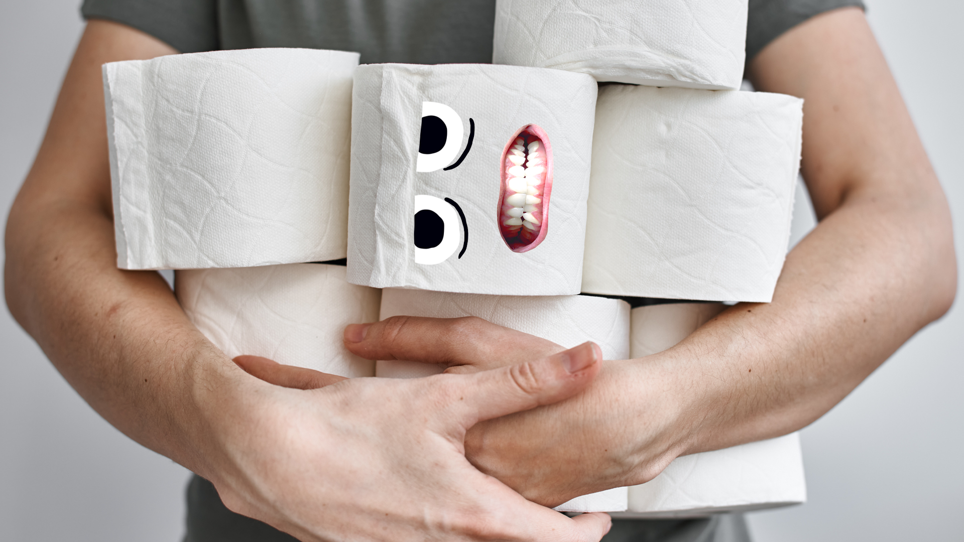 A man holding lots of toilet rolls