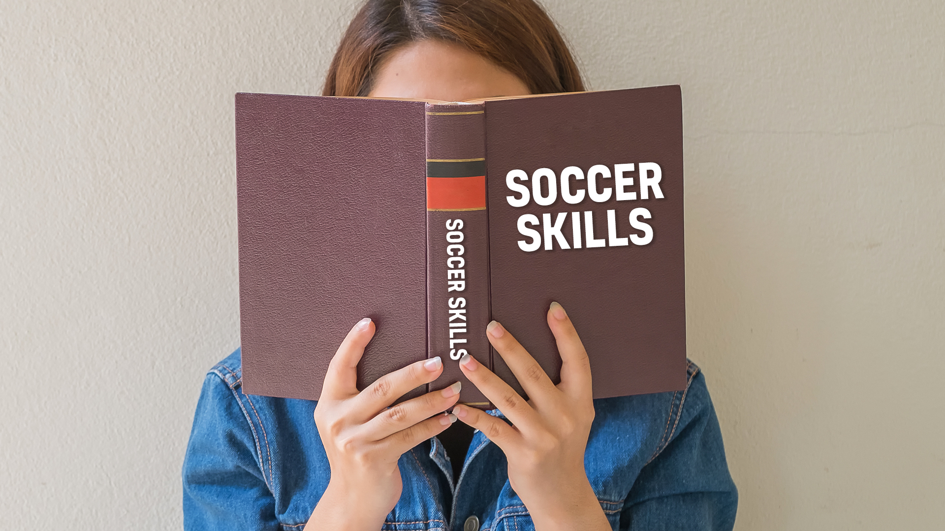 A person reading a Soccer Skills book