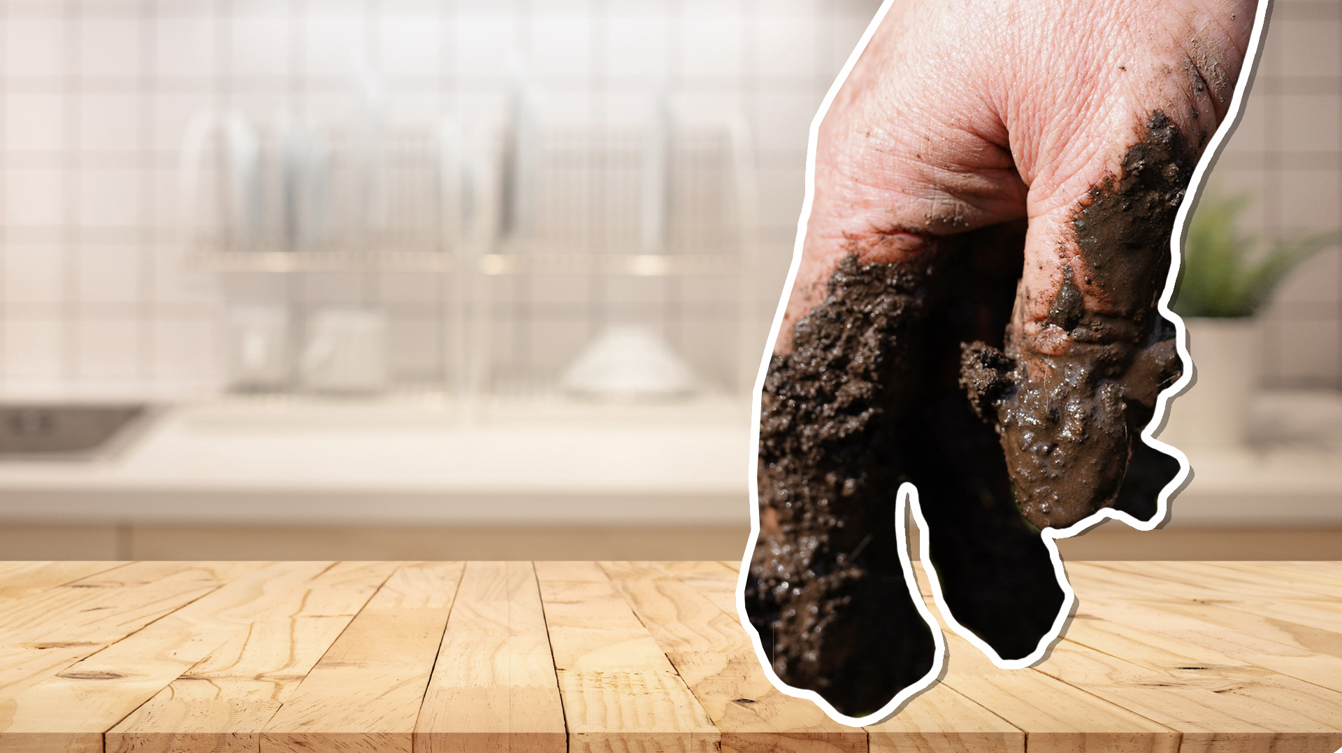 A muddy hand in a clean kitchen