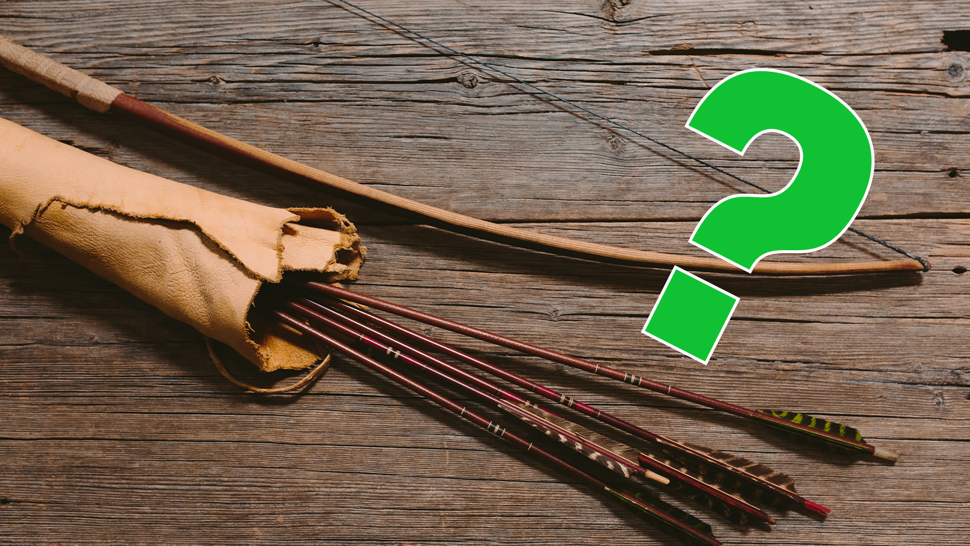 Bow and arrows on wooden background with green question mark