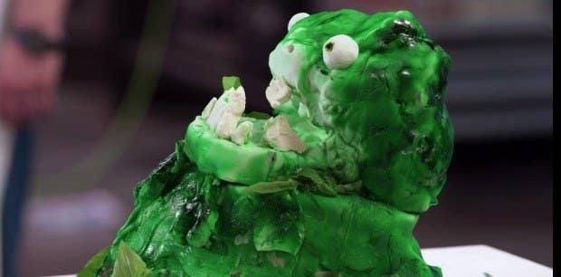 A green cake with a face