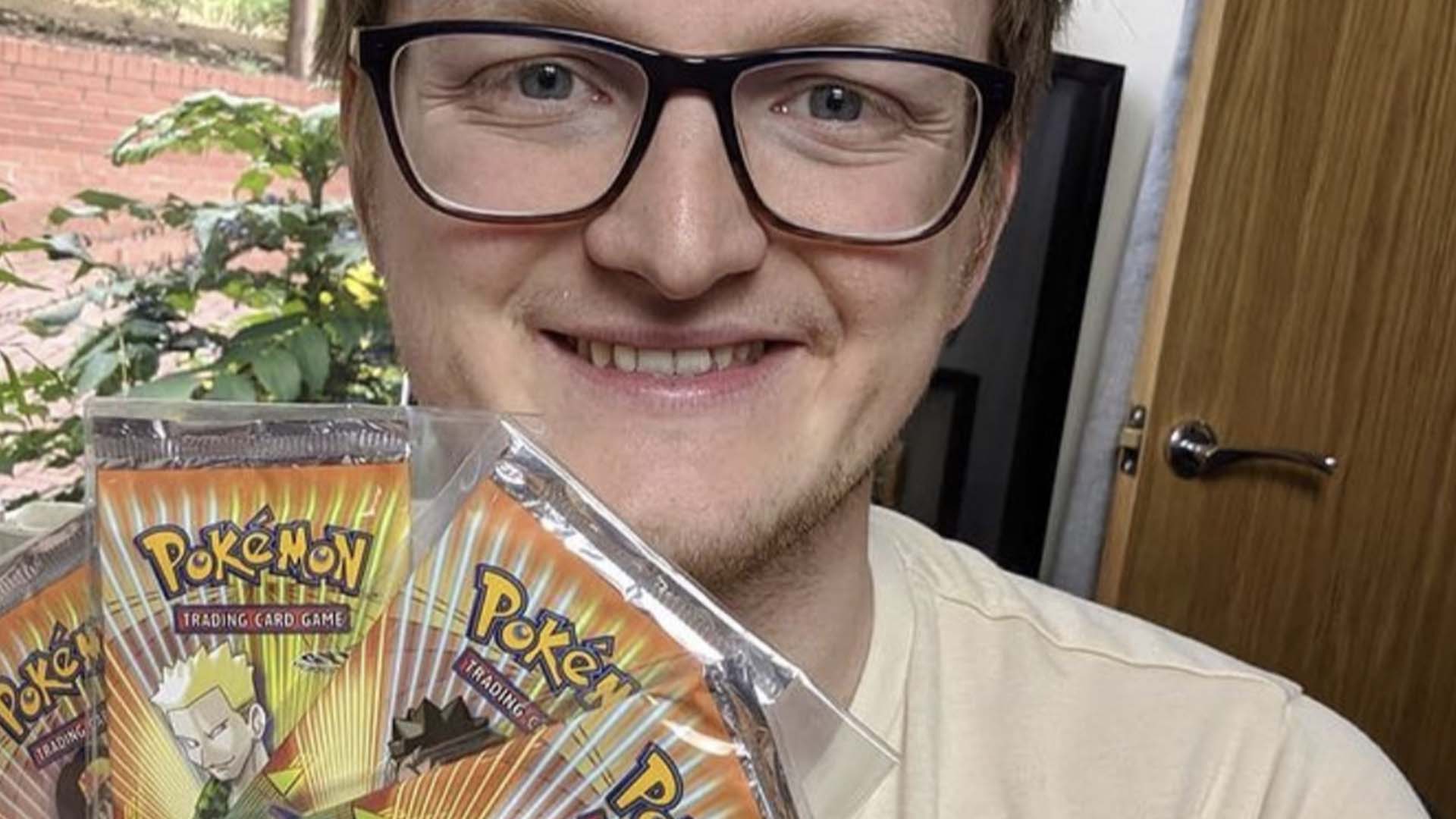 Grian holding a collection of Pokémon cards