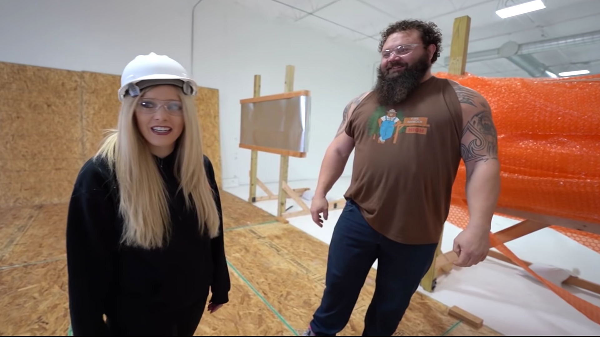Brianna in hardhat with construction worker