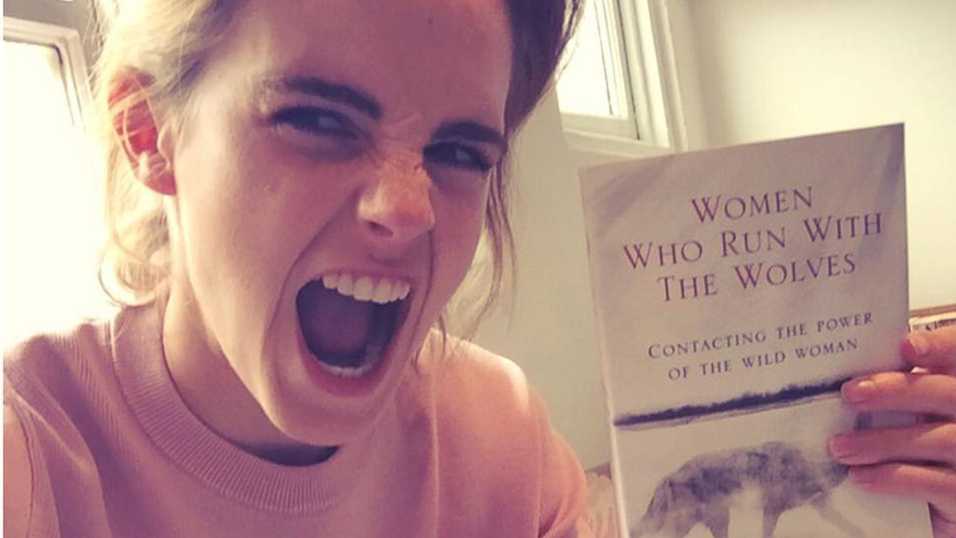 Emma Watson holding a book