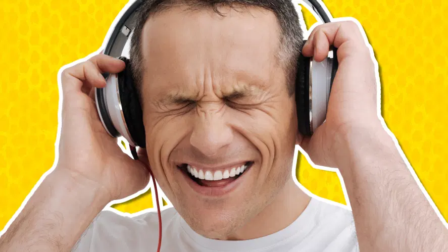 A man listening to music on big headphones