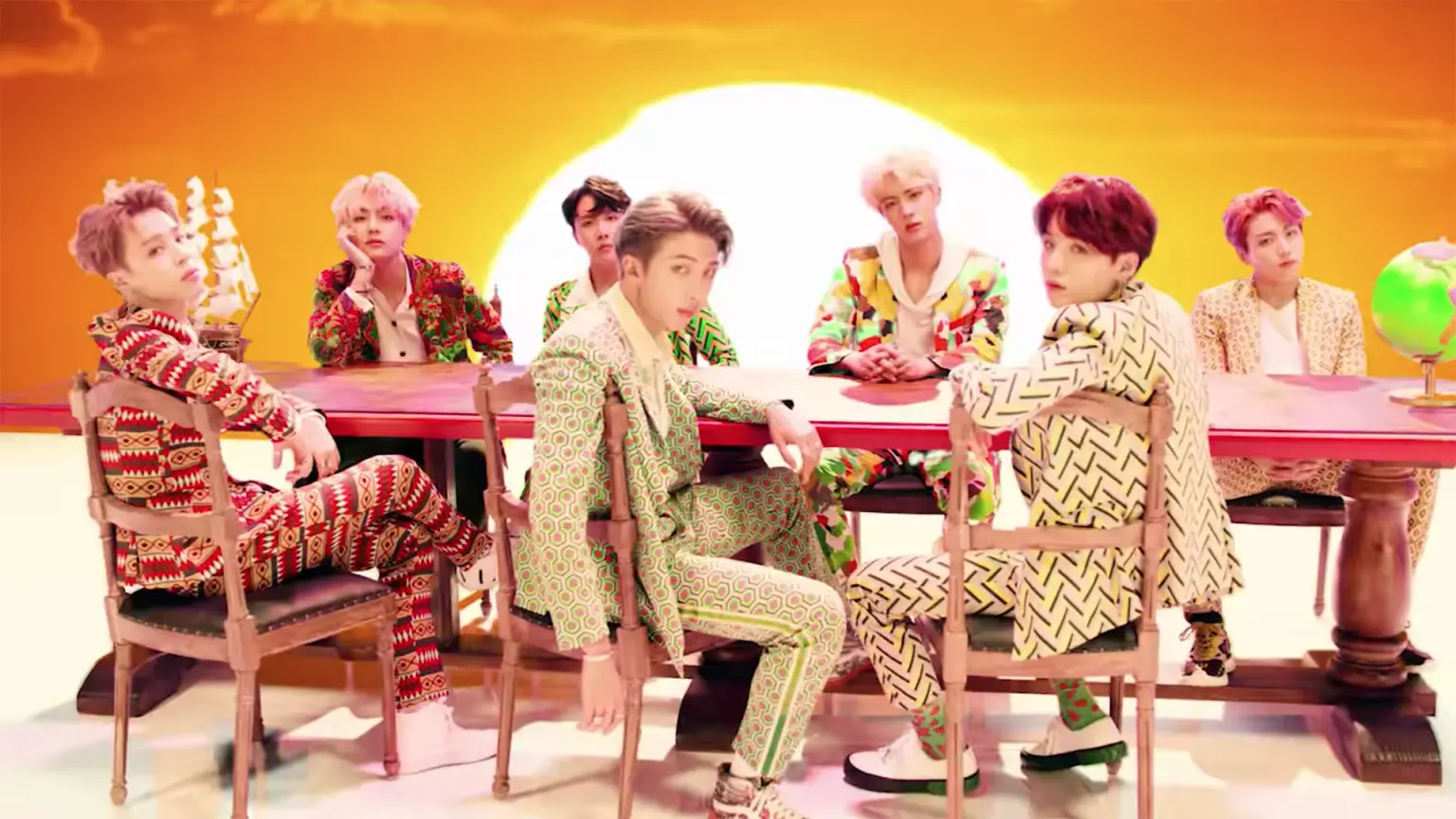 BTS sitting at a big dining table