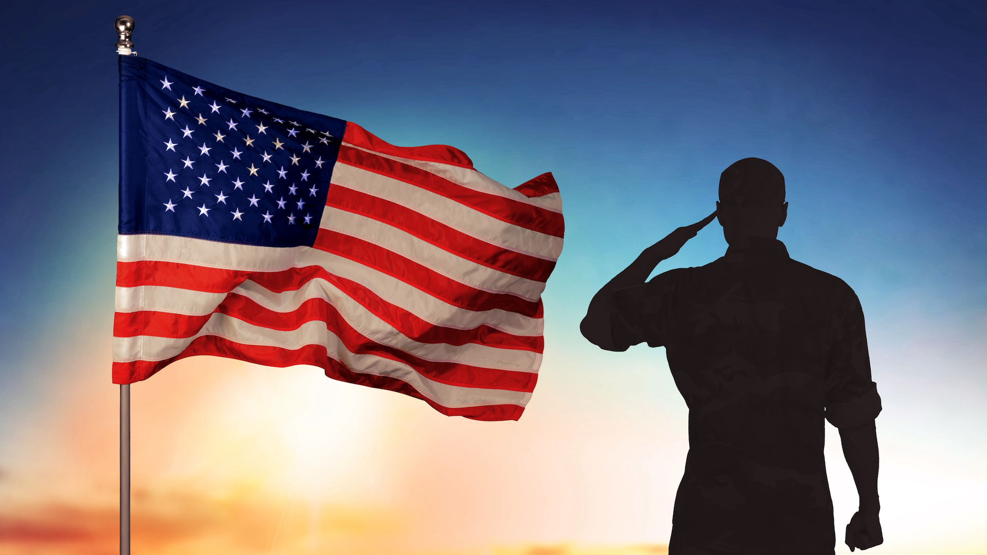 A person saluting next to the USA flag