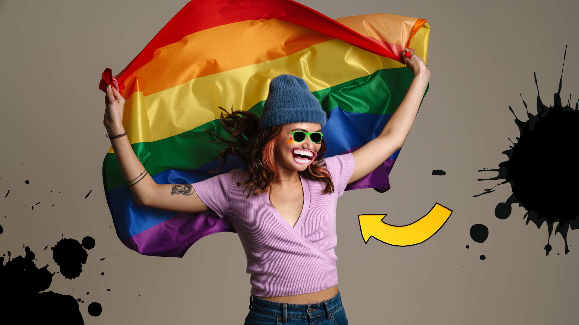 A happy woman with a rainbow flag