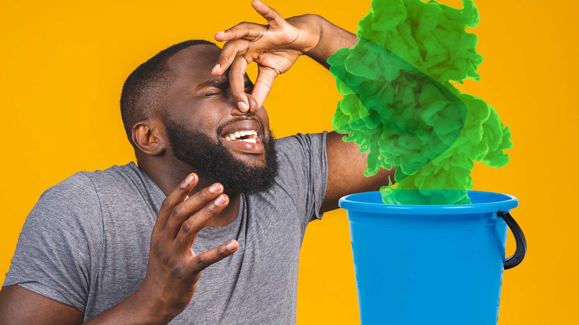 A man holding his nose over a bucket