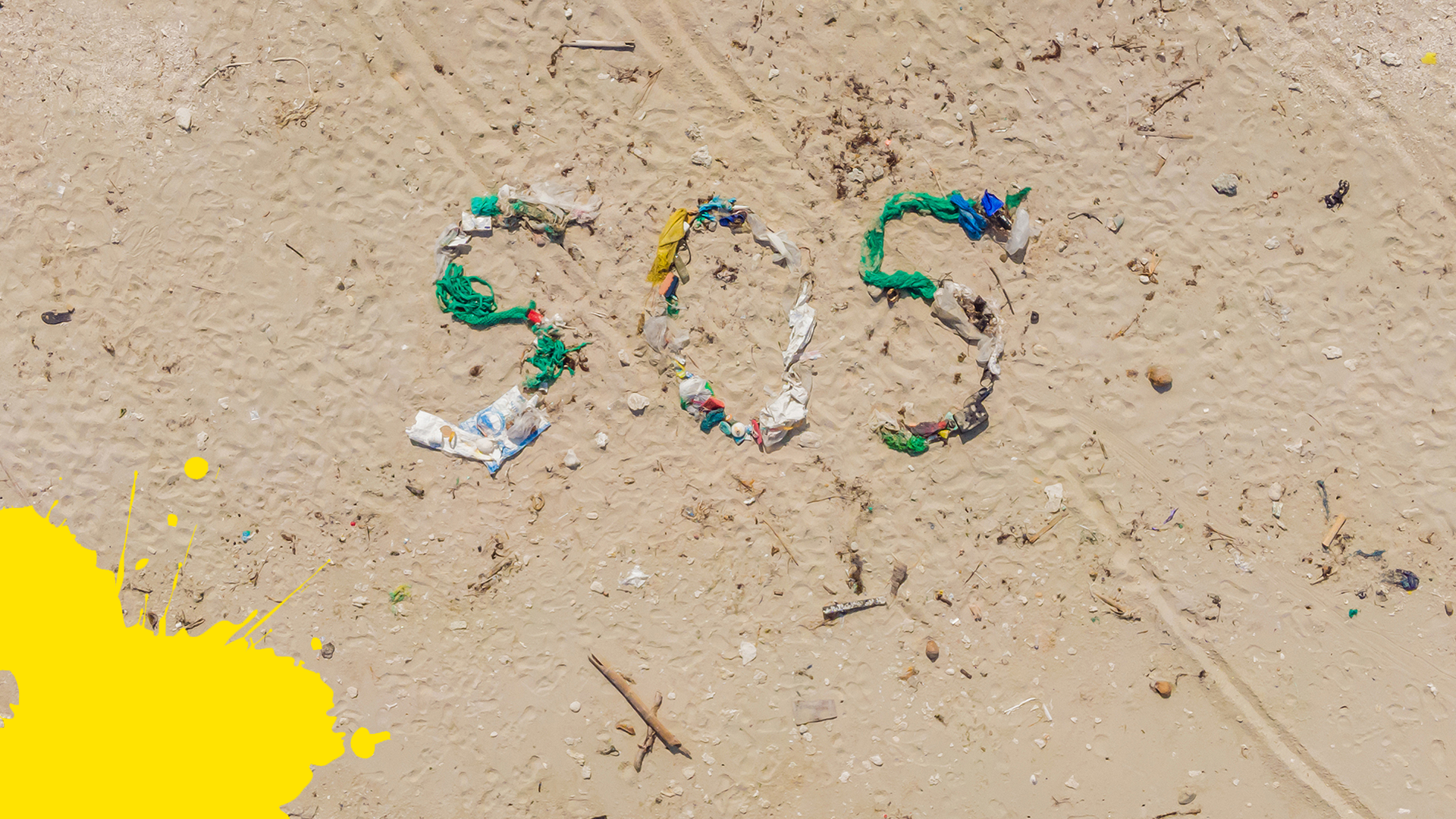 Beach with SOS spelled out with debris