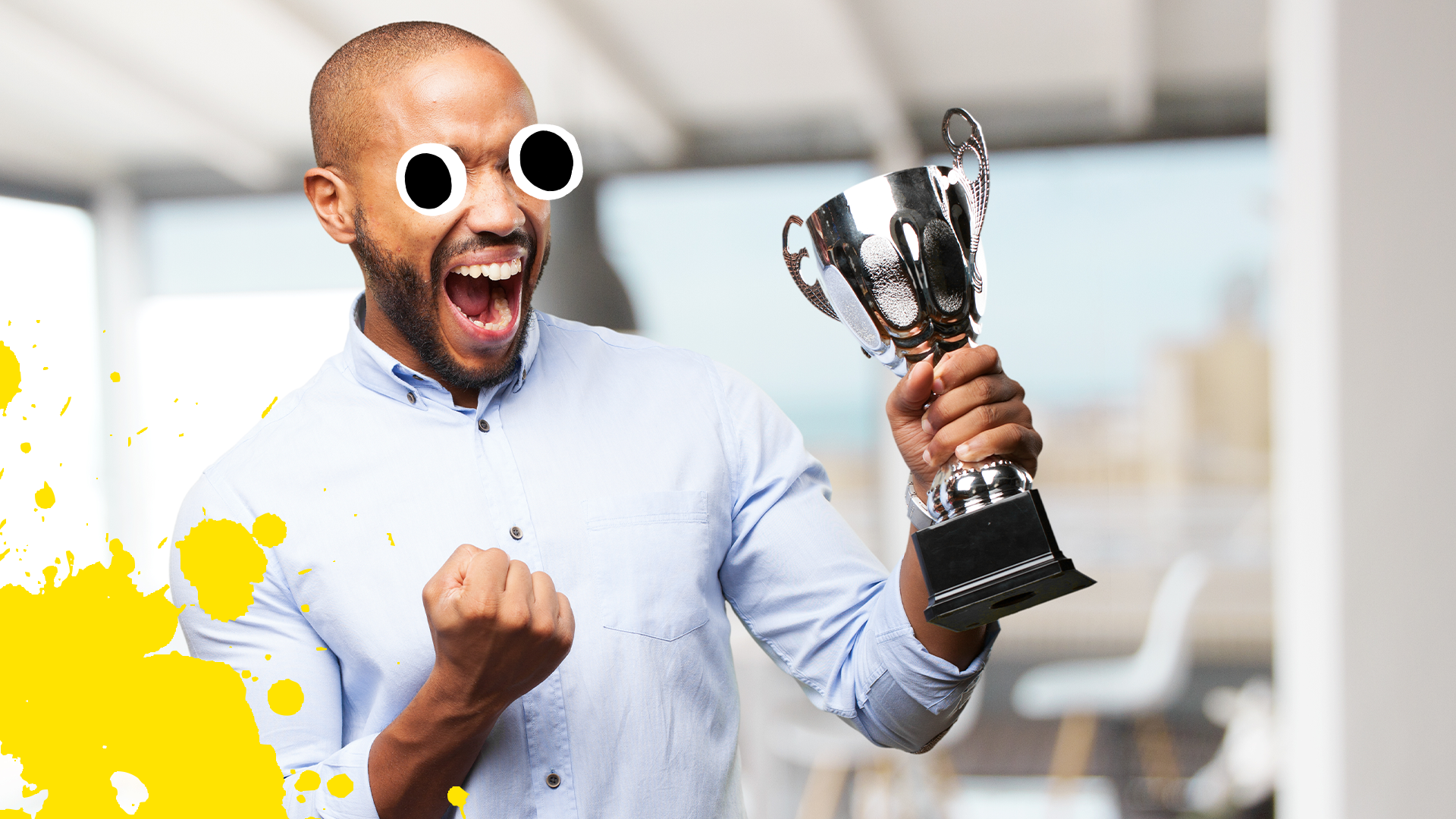 Man with trophy celebrating with yellow splat 