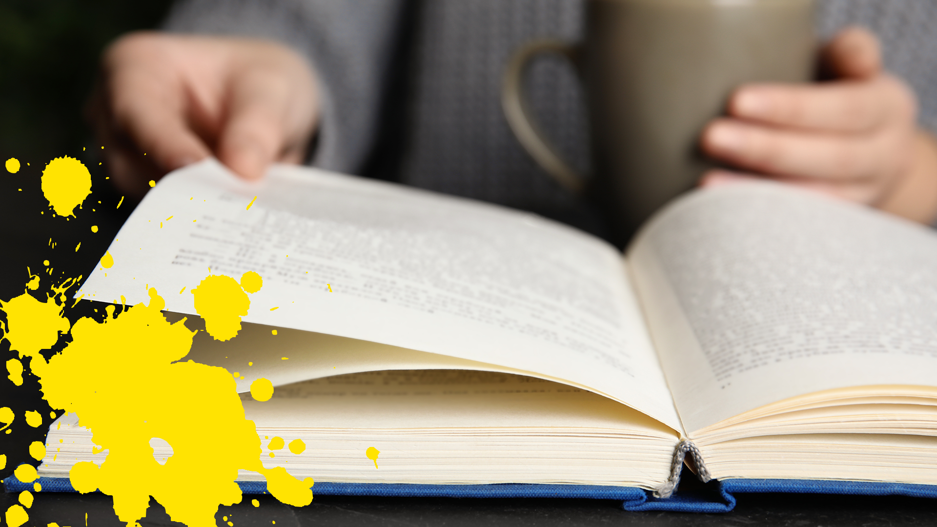 Someone reading a book with yellow splat