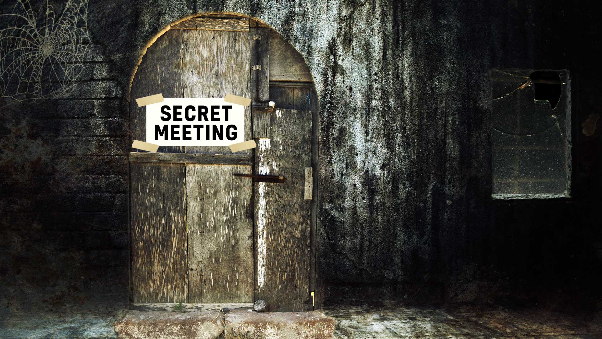 A door with a note saying Secret Meeting