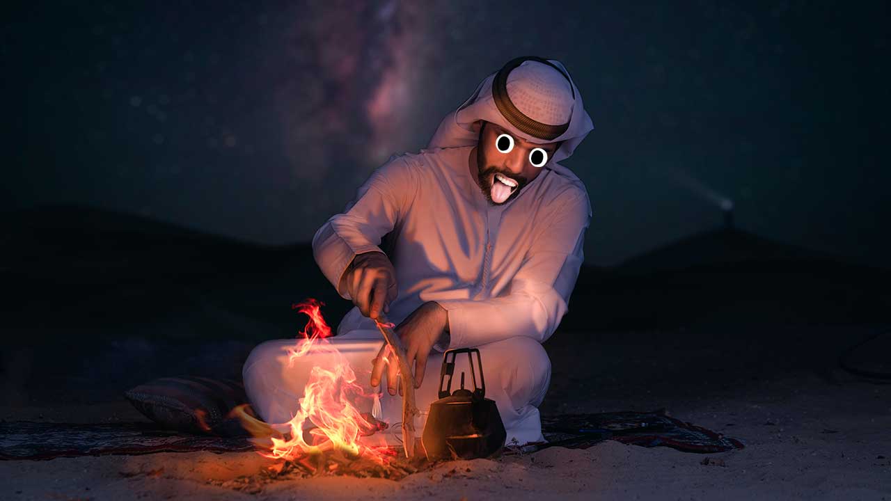 A man preparing a fire in the desert